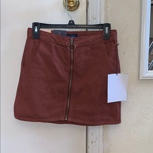 Mauve colored denim zip up skirt.